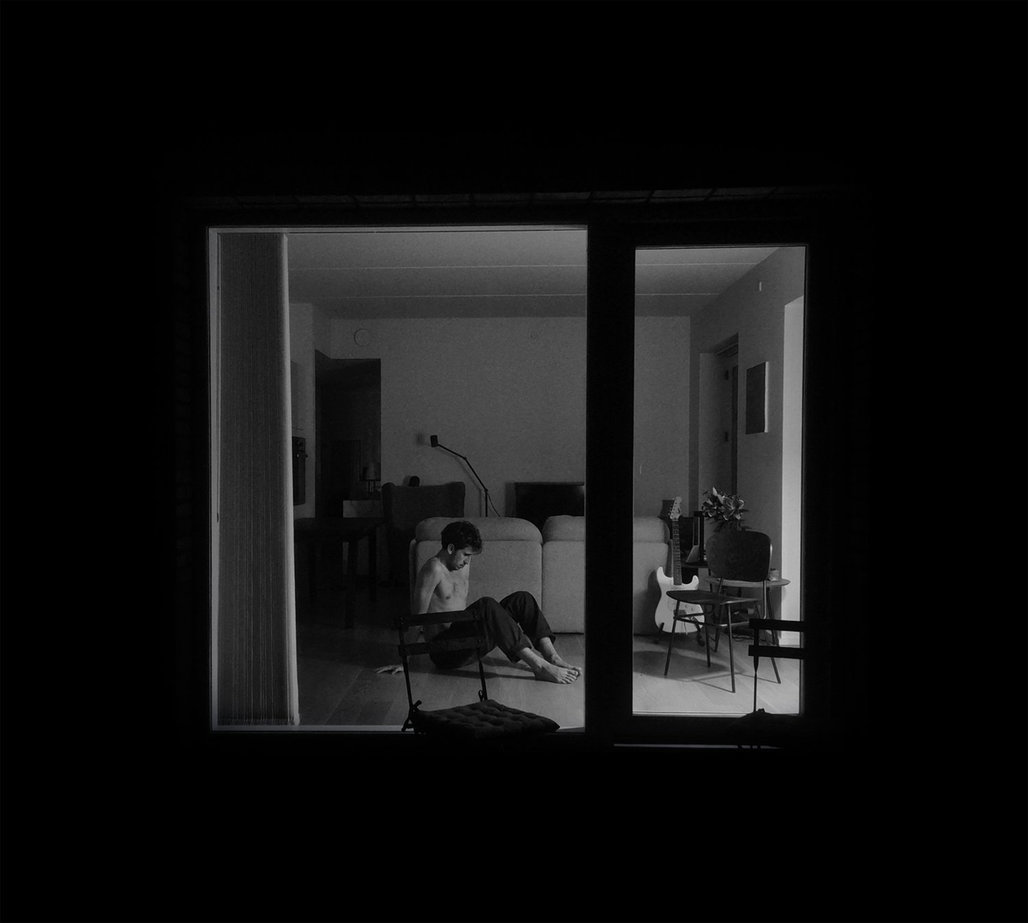 _morfema (Lluís Colomer Coll), photographed through a window in his apartment in Copenhagen, 2026.